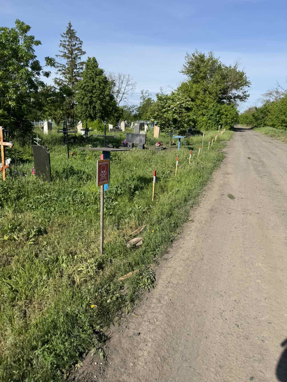 Hazard marking along the road at the Ivanivka clearance site